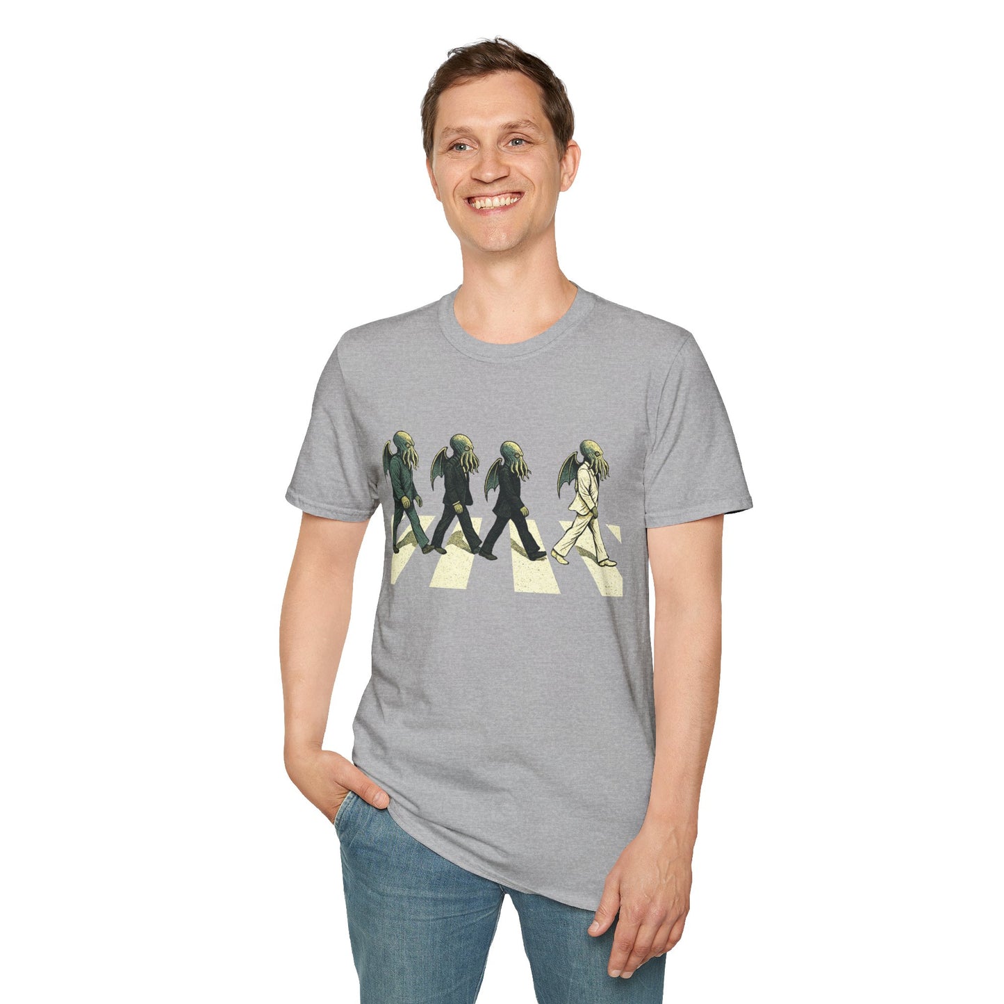 Person wearing a gray t-shirt with a graphic design of 4 Cthulhus wearing suits crossing a road on a white background