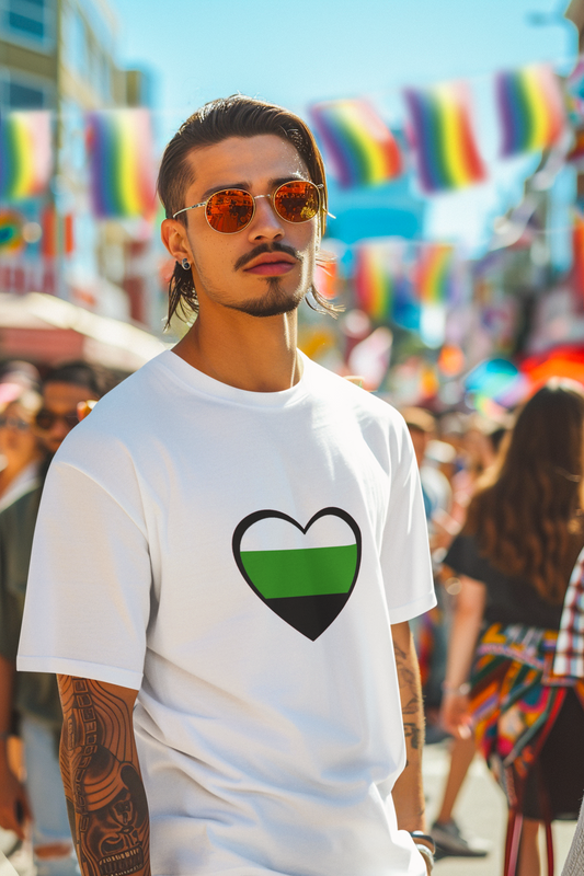 Man in sunglasses wears the Aromantic Heart Pride T-Shirt in white at a vibrant outdoor pride celebration, with rainbow flags waving in the background. Shirt design features a minimalist neutrois heart graphic representing neutrois pride flag meaning.
