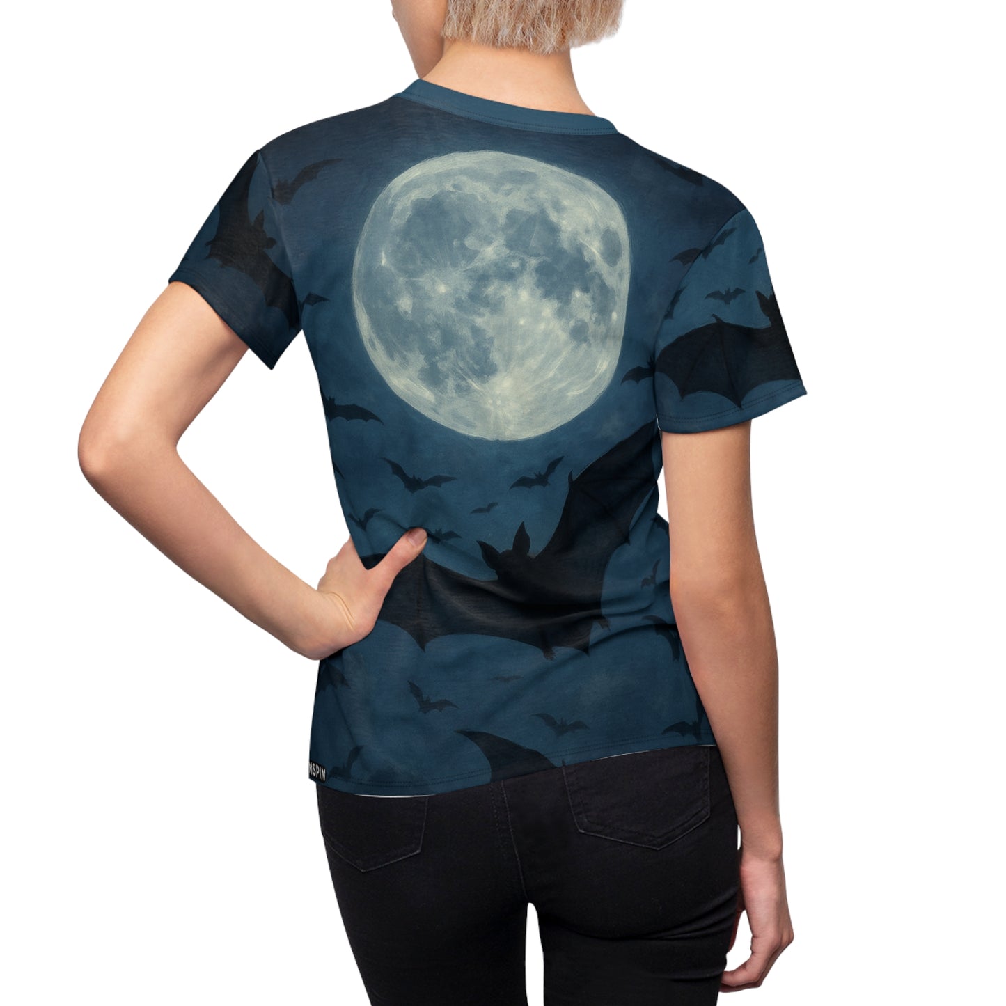 Rear view of the Bats in the Sky Women’s AOP Shirt – Night Sky Bat All-Over Print worn by a woman, featuring a luminous full moon surrounded by flying bats.