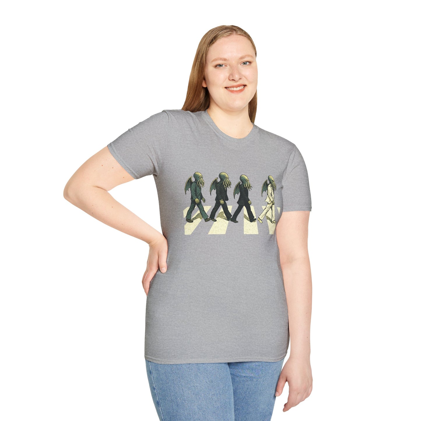 Person wearing a gray t-shirt with a graphic design of 4 Cthulhus wearing suits crossing a street on a white background