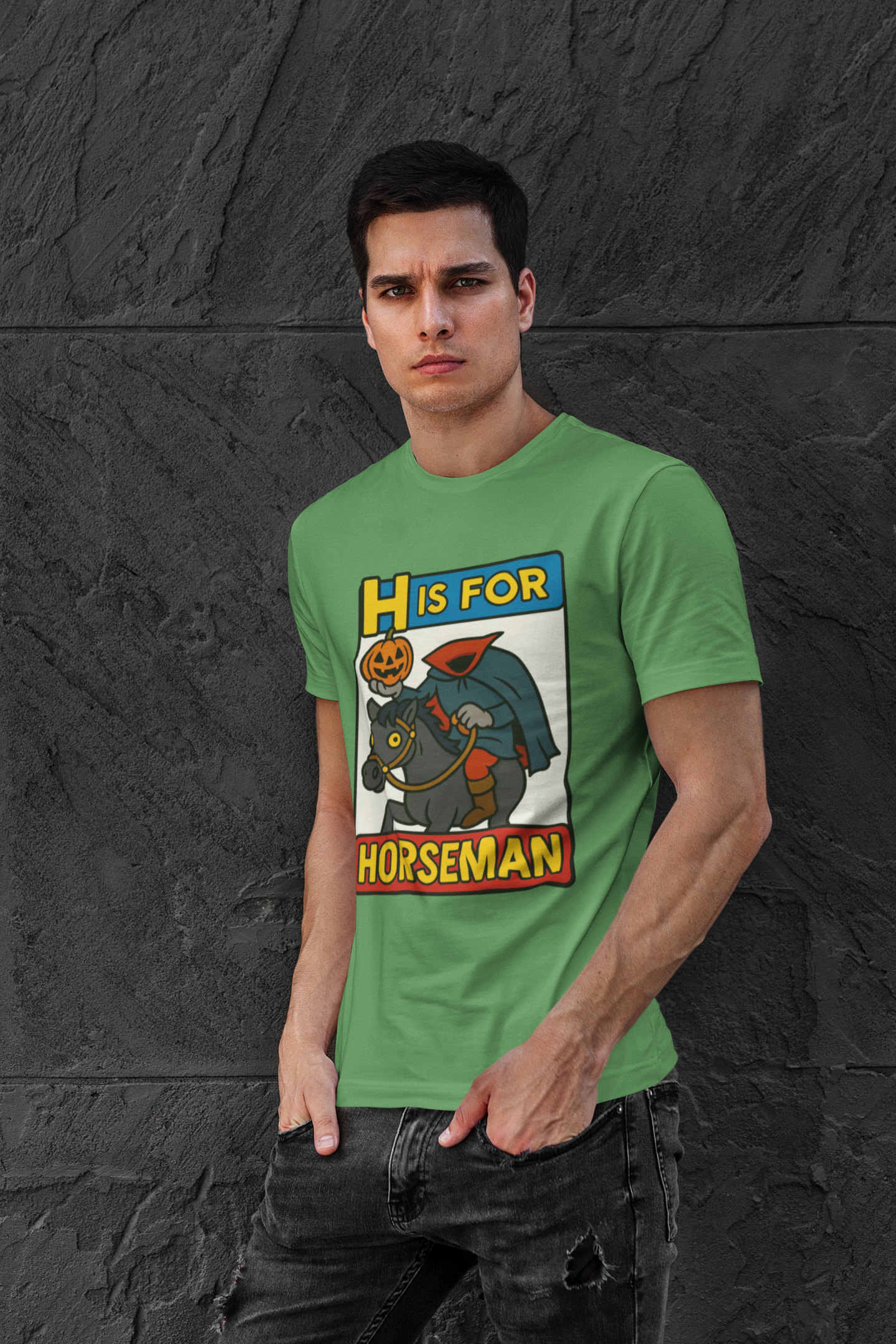 H is for Horseman T-Shirt – Headless Horseman Halloween Tee in leaf green, lifestyle photo with bold cartoon pumpkin-headed rider, funny Halloween horseman shirt.