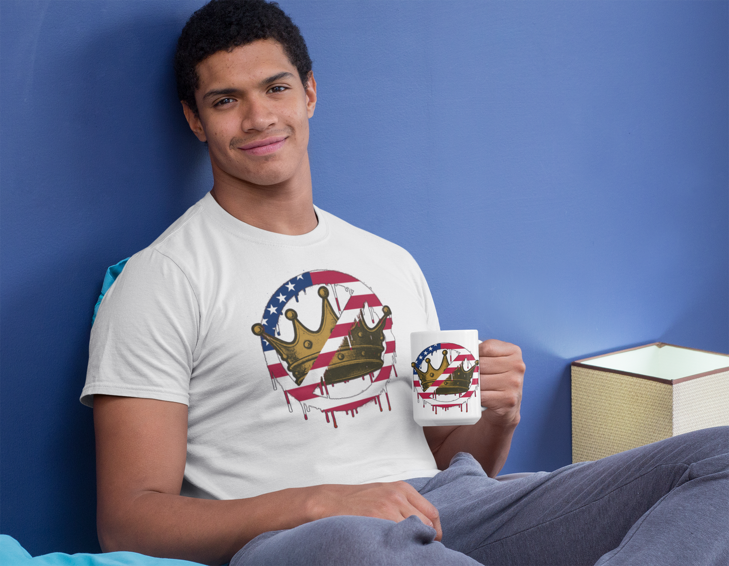 No Kings Mug – Anti-Monarchy Coffee Cup held by a man seated on bed while wearing the matching “No Kings” shirt, relaxed indoor setting adds modern edge.