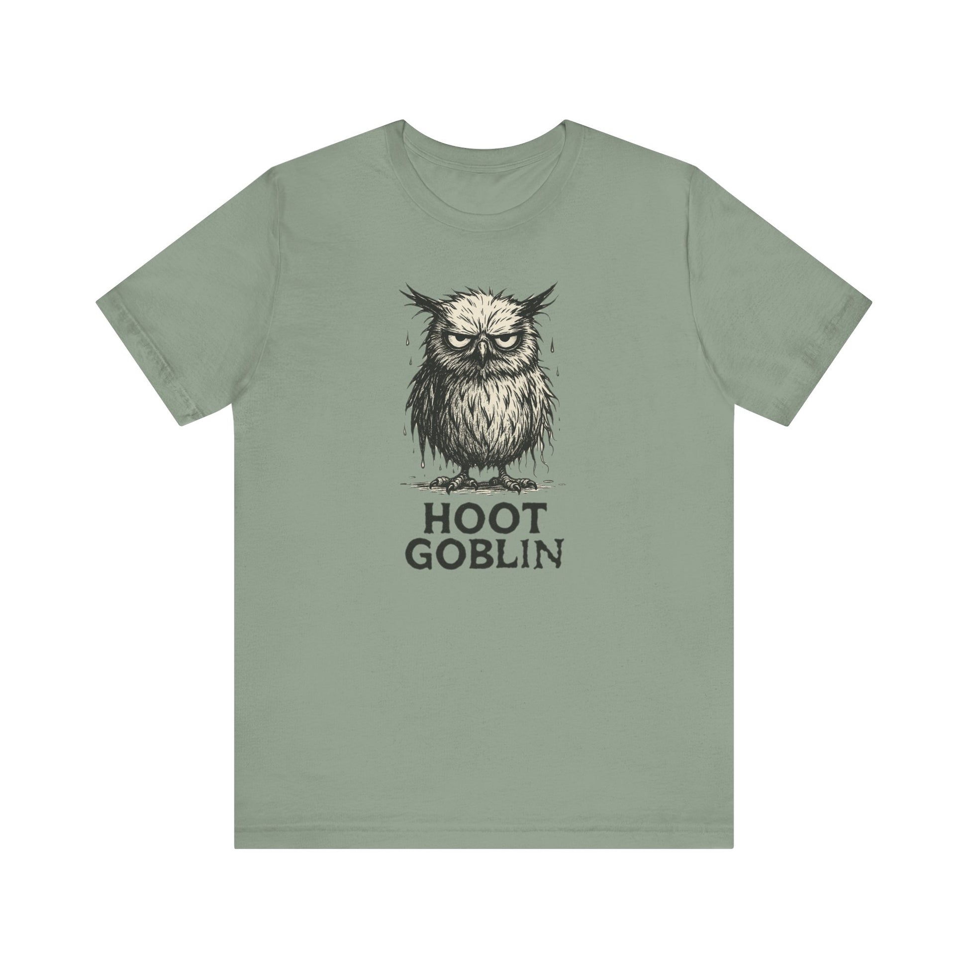 Sage green t-shirt with a sad owl design and 'Hoot Goblin' text on a white background