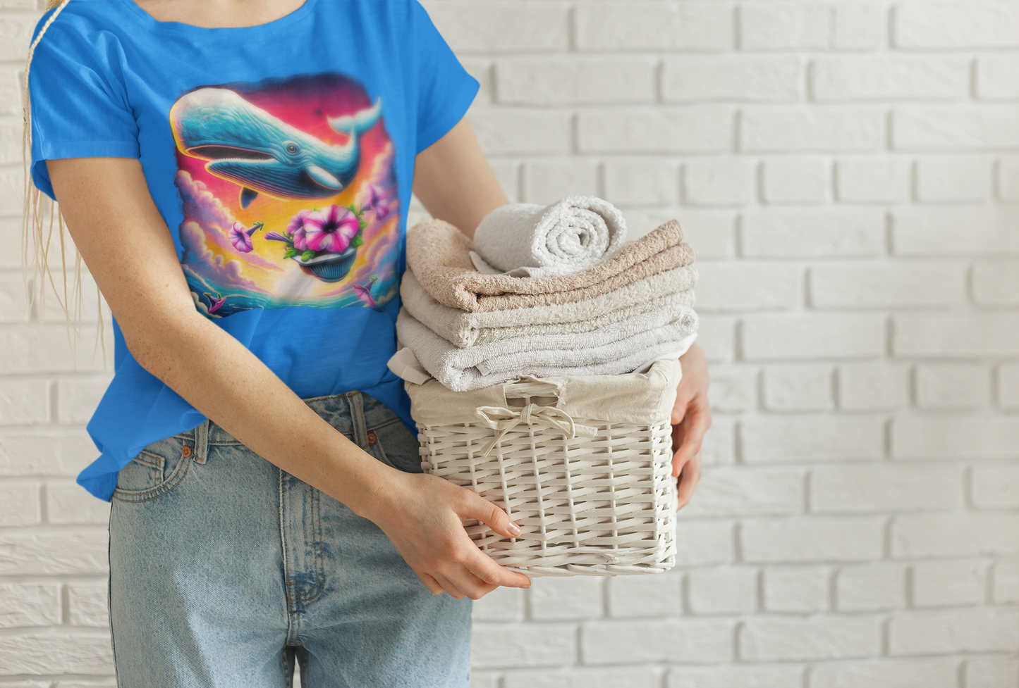 Woman holding laundry basket in whale tee "Oh No Not Again" Petunias and Whale Tee – sci-fi inspired surreal graphic tee featuring whale and petunias, ideal for fans of Hitchhiker’s Guide humor and laundry-day style