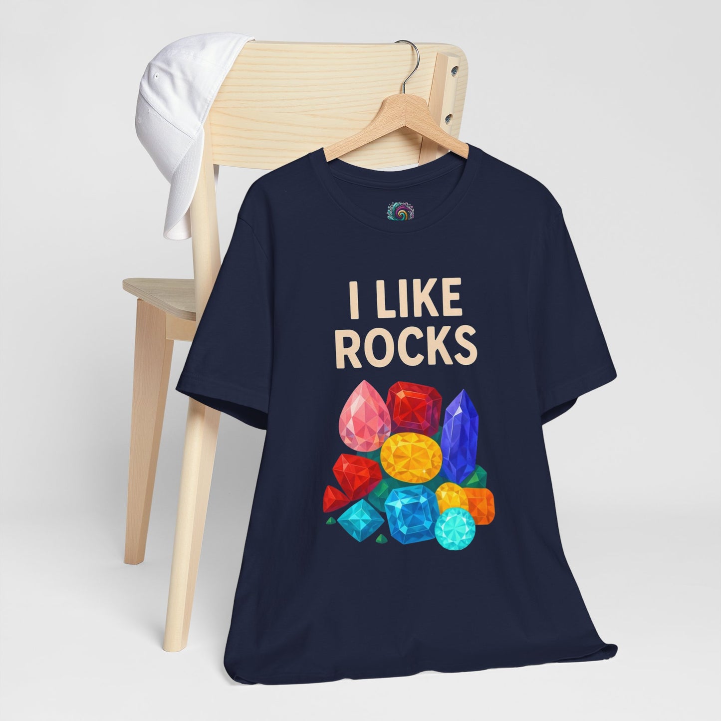 Navy blue I Like Rocks shirt from Whimspin with "I like rocks" text and colorful gemstone graphics on a white background.