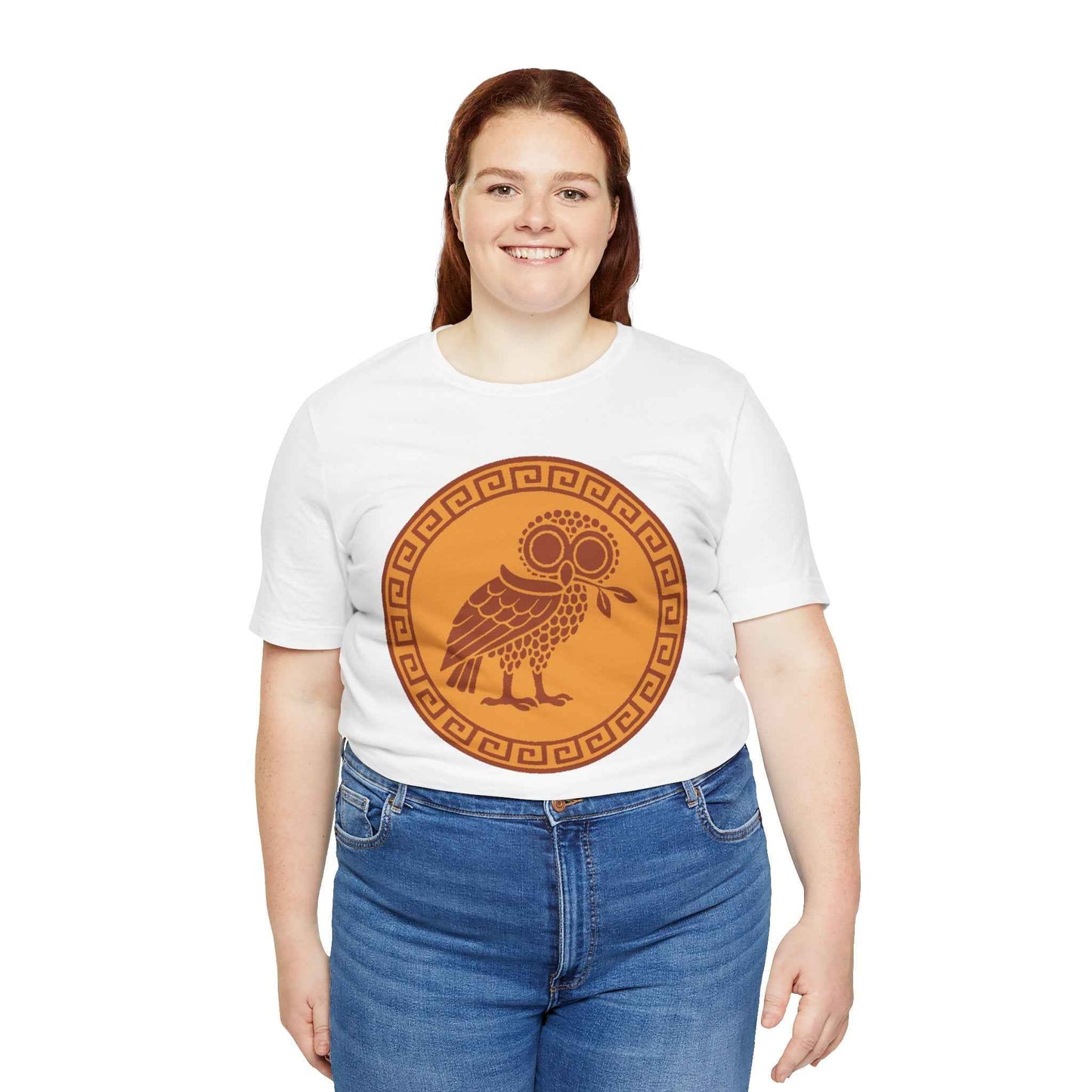 A plus sized woman wearing a white t-shirt with an terra cotta owl design on a white background