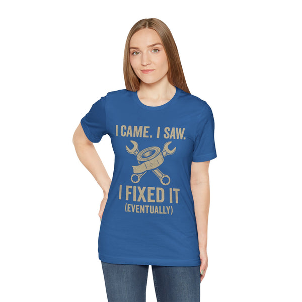 Blue crewneck T-shirt with gold “I Came, I Saw… I Fixed It (Eventually)” graphic print.
