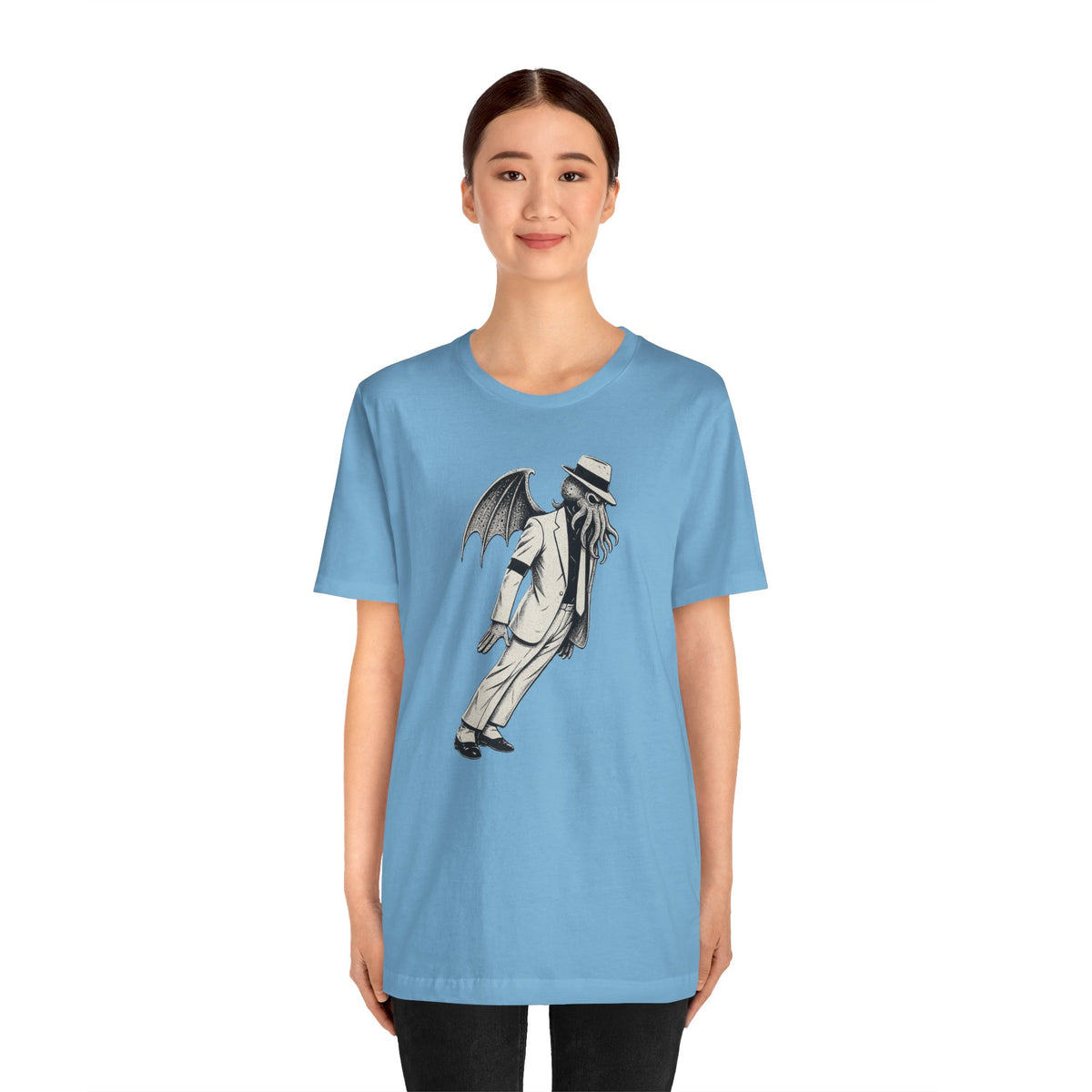 Light blue crewneck graphic t-shirt on model, featuring a black-and-gray winged character