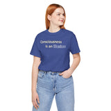 Blue crewneck t-shirt with “Consciousness is an Illusion” graphic, model looking left