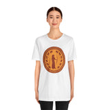 White crewneck T-shirt with circular bronze queen graphic, worn by model