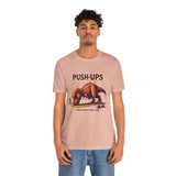 Pink graphic T-shirt with “PUSH-UPS” and T-rex workout dinosaur print, crew neck