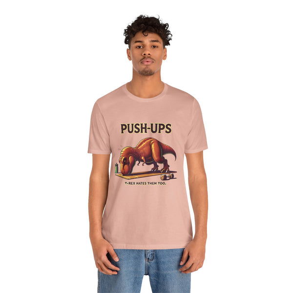 Pink graphic T-shirt with “PUSH-UPS” and T-rex workout dinosaur print, crew neck