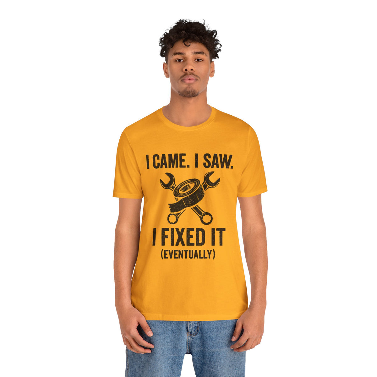 Orange crew-neck T-shirt with black tool graphic and text "I FIXED IT (EVENTUALLY)"