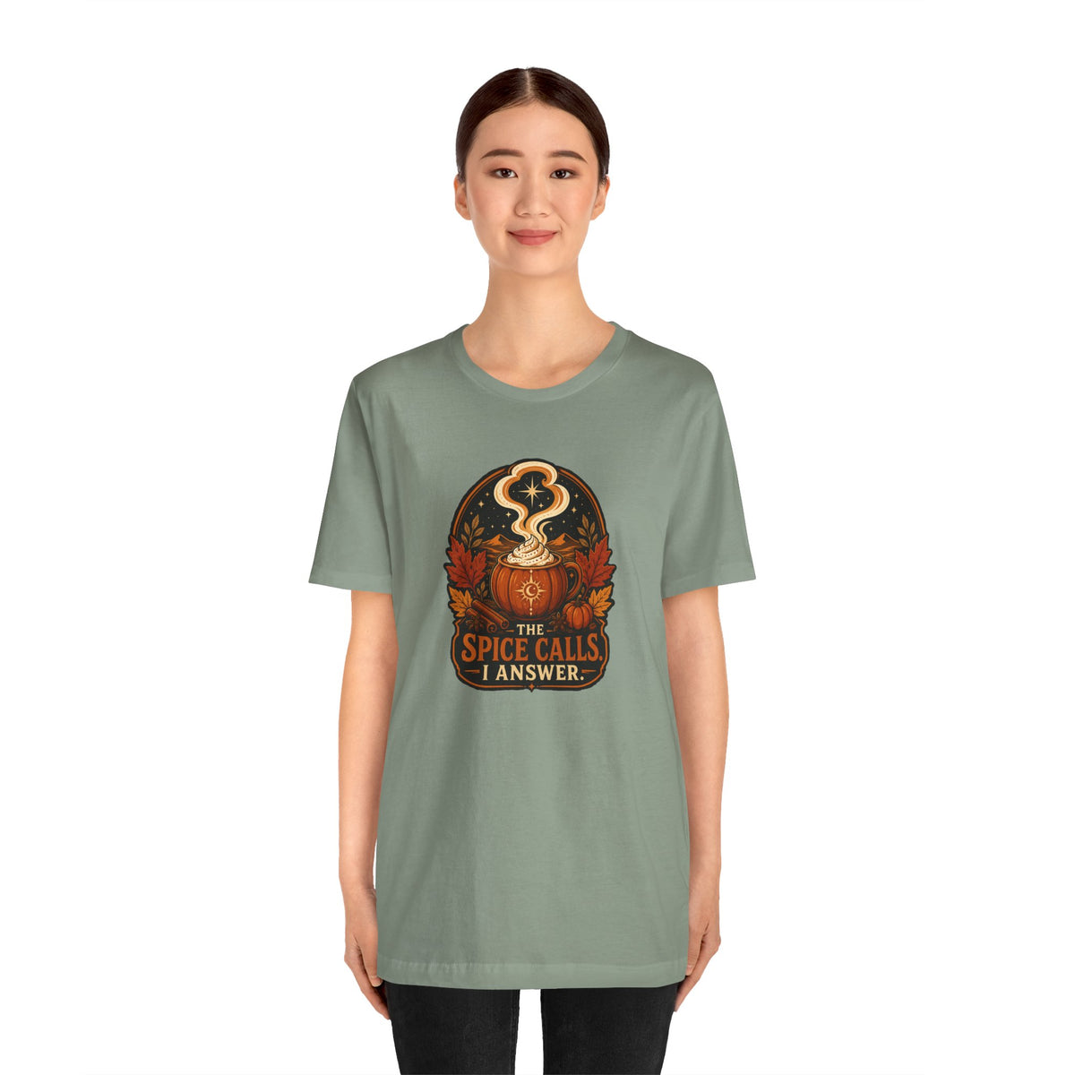 Sage green crewneck T-shirt with front pumpkin spice graphic, straight hem.
