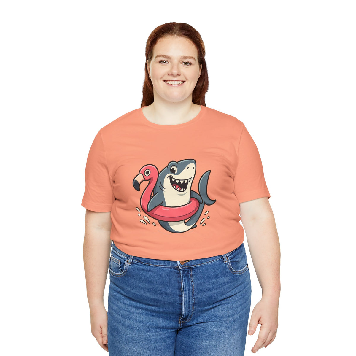 Coral crewneck T-shirt with shark and flamingo floatie graphic on chest