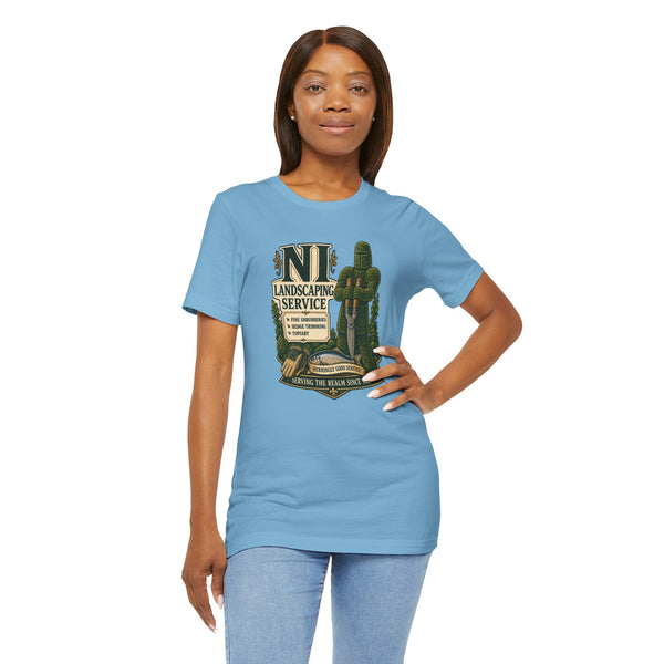 Light blue crewneck T-shirt with chest “NI Landscaping Service” graphic, worn by woman.