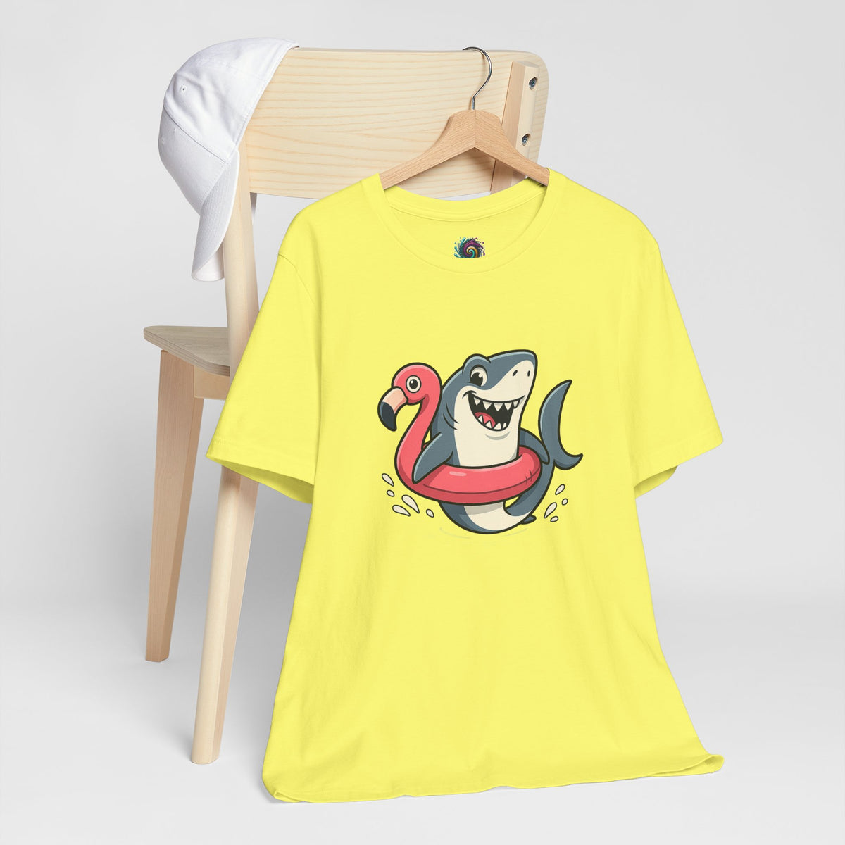 Lime yellow crewneck T-shirt with shark and flamingo float graphic, on hanger