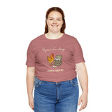 Rose mauve crew-neck T-shirt with chicken and egg dealer graphic, worn by woman