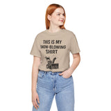 Tan short-sleeve T-shirt with “THIS IS MY SNOW-BLOWING SHIRT” text and snow blower graphic.