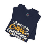 Navy folded T-shirts with multicolor “Powered by Caffeine and Questionable Methods” graphic