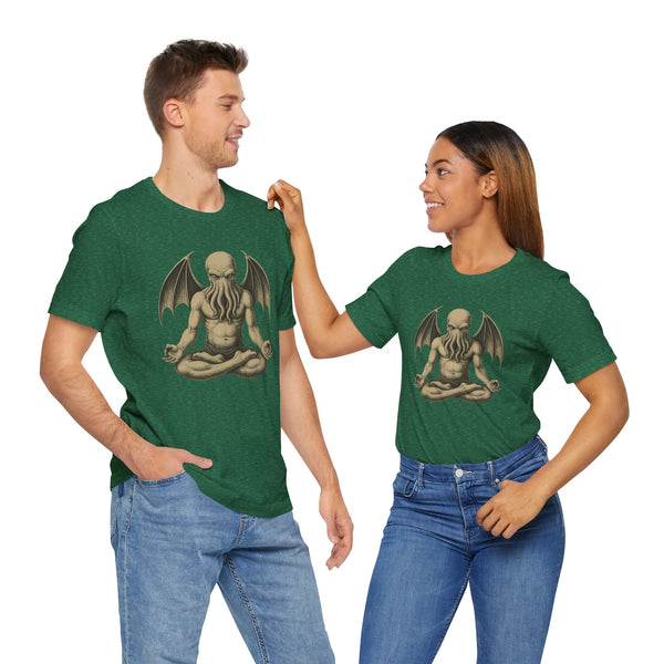 Pair of people wearing green unisex T-shirts with a meditating monster chest graphic