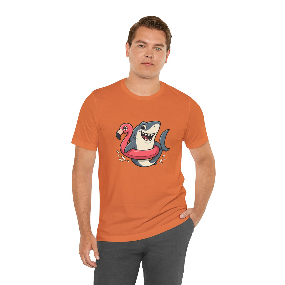 Orange crewneck T-shirt with shark and flamingo floatie graphic, male model standing.
