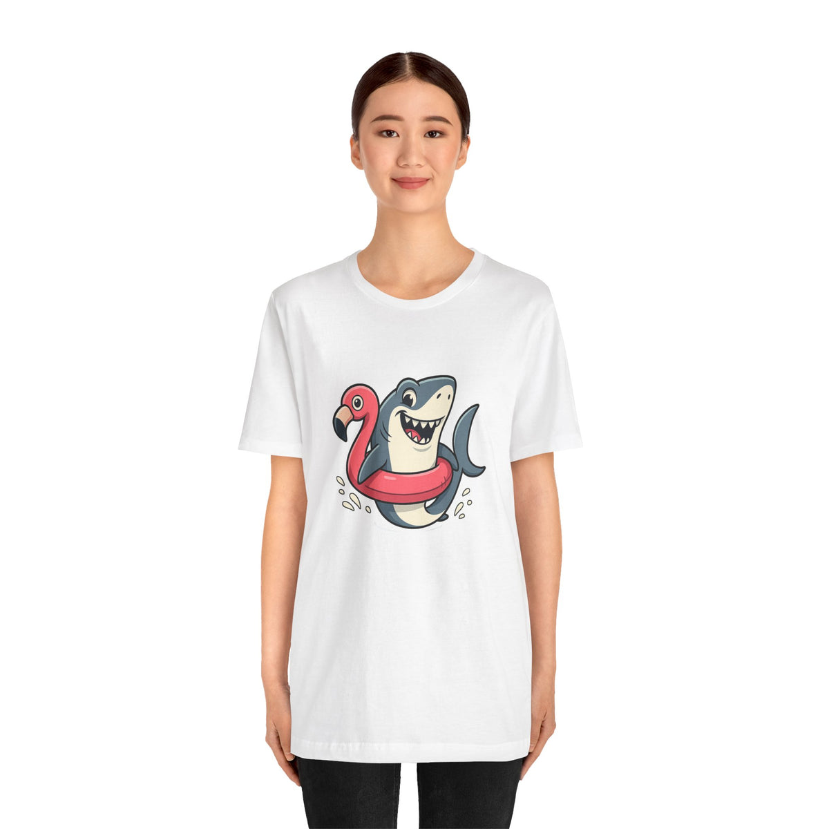 White crew-neck T-shirt featuring a smiling shark on a flamingo float graphic