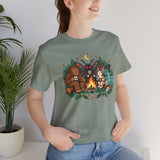 Sage green crewneck T-shirt with colorful campfire cryptid graphic on the chest