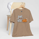 Brown crewneck t-shirt with cat and turkey front graphic, hanging on wooden hanger