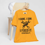 Orange crew-neck T-shirt on hanger, with black repair-themed graphic and slogan text