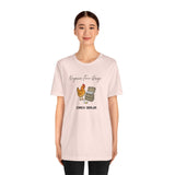 Soft pink crewneck T-shirt worn by model, chicken and egg graphic at center