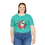 Teal crew-neck T-shirt with shark and flamingo floatie graphic, worn by woman