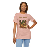 Pink crewneck t-shirt with dragon reading stacked books graphic, hands on hip