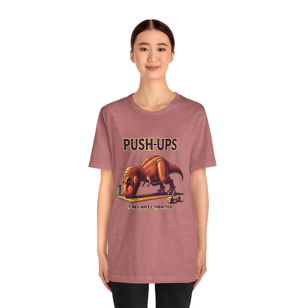 Rose short-sleeve T-shirt featuring a dinosaur push-ups graphic on the chest