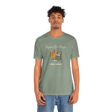 Green crew-neck graphic T-shirt worn by male model with chicken-and-eggs “Crack dealer”