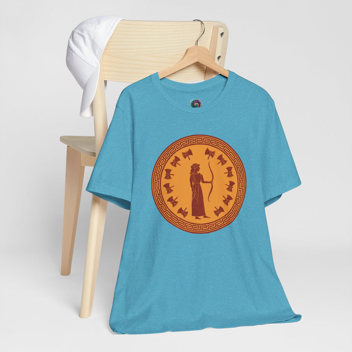 Sky blue crewneck T-shirt on hanger with large orange circular Greek-style goddess graphic