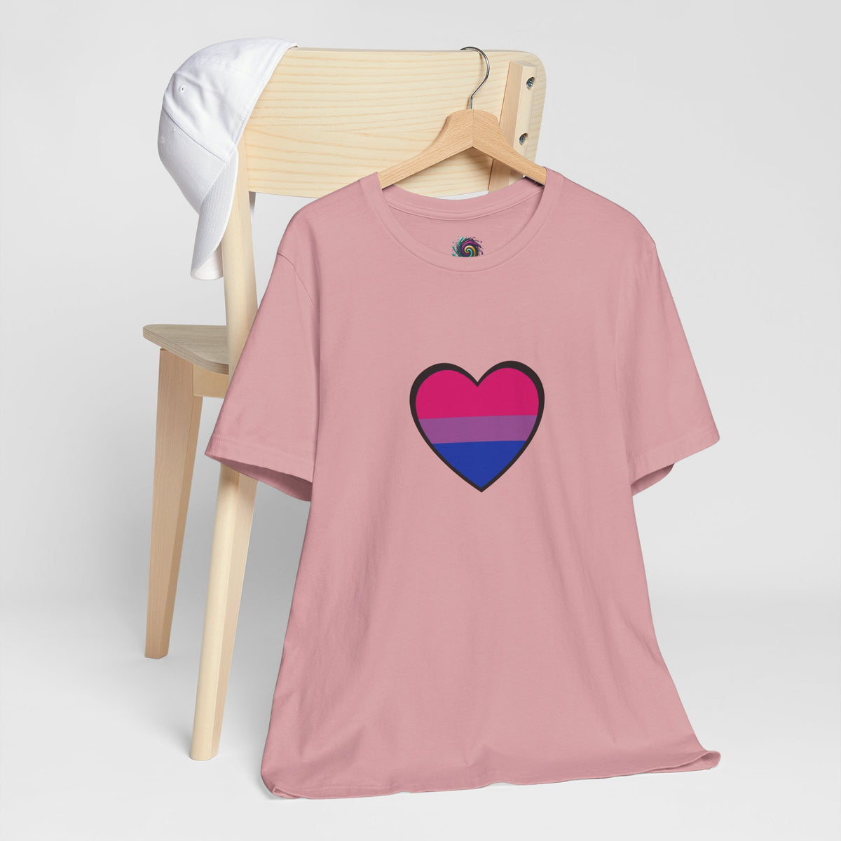 Soft pink T-shirt on a hanger with outlined heart Pride flag graphic