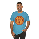 Sky blue crewneck T-shirt with large orange circular Greek-style goddess graphic, front view