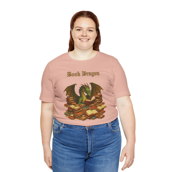 Pink crewneck t-shirt with dragon reading stacked books graphic, crew neckline