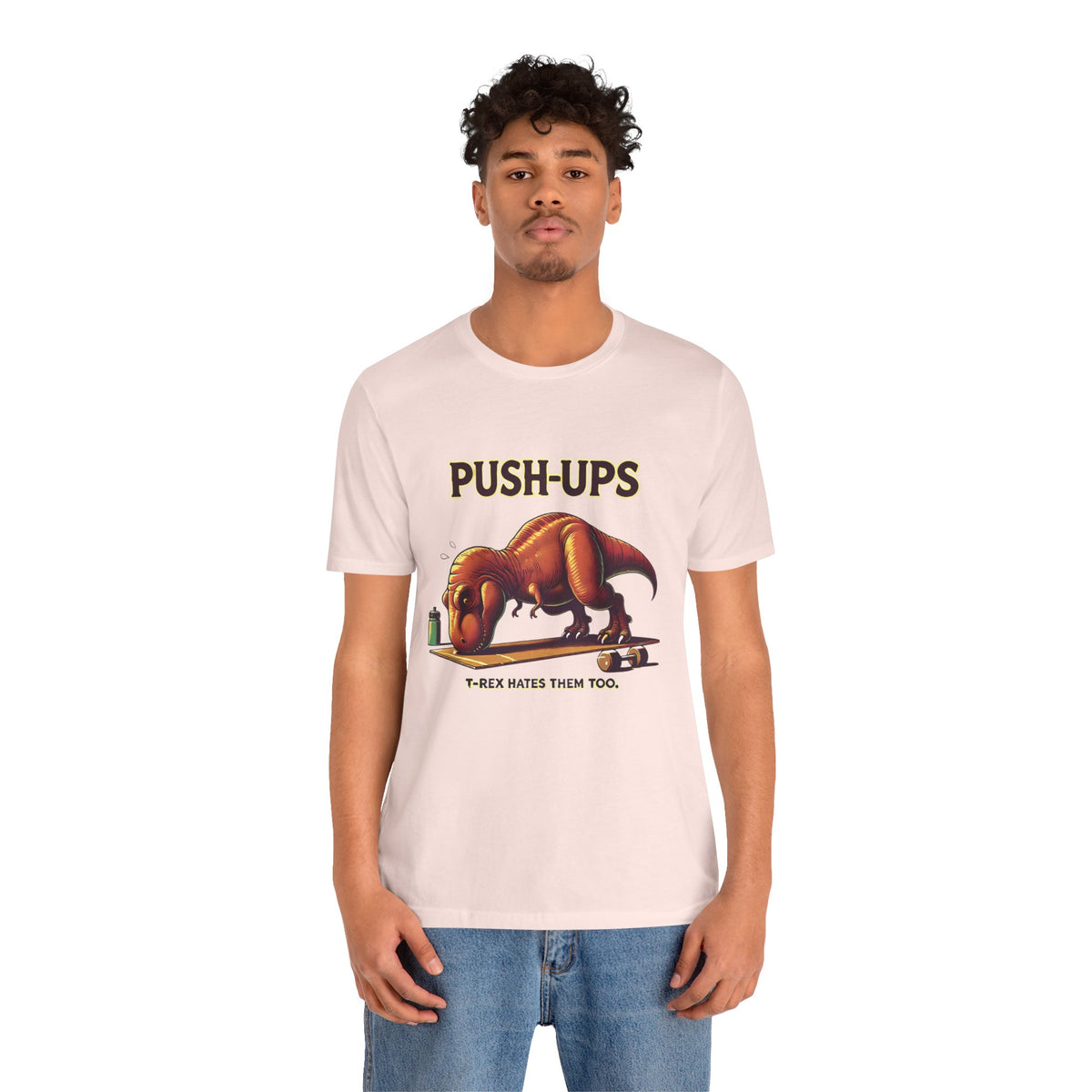 Pink crew-neck graphic T-shirt displaying “PUSH-UPS” and T-Rex push-up art