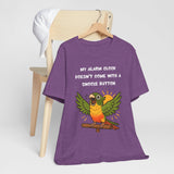 Purple crew-neck t-shirt with printed parrot graphic and “My alarm clock” message