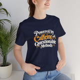Navy crewneck T-shirt with multicolor “Powered by Caffeine and Questionable Methods” graphic