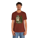 Rust-brown crewneck T-shirt with centered green-and-brown badge-style graphic