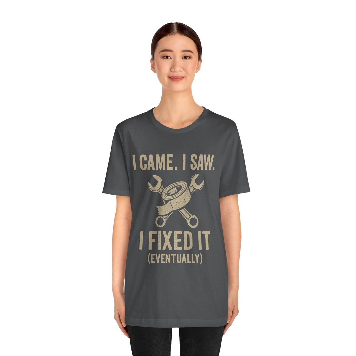 Charcoal short-sleeve tee with centered gold text slogan and crossed tools graphic