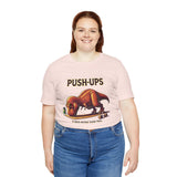 Pink crew-neck T-shirt with “PUSH-UPS” headline and T-Rex push-up illustration