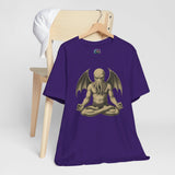 Team purple unisex crewneck T-shirt with meditating Cthulhu graphic, shown laid on a stand