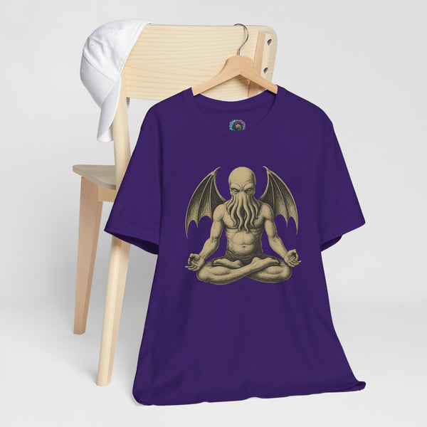 Team purple unisex crewneck T-shirt with meditating Cthulhu graphic, shown laid on a stand