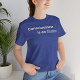 Blue crewneck t-shirt close-up with “Consciousness is an Illusion” chest graphic