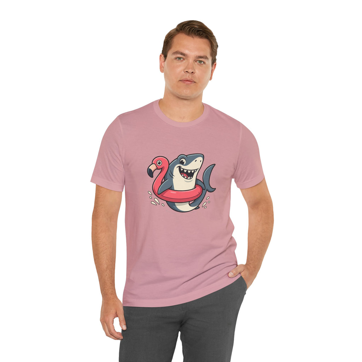 Pink short-sleeve crew-neck T-shirt with shark holding flamingo floatie graphic