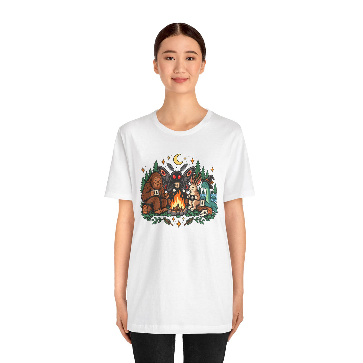 White crew-neck campfire cryptid tee with colorful front graphic of three characters